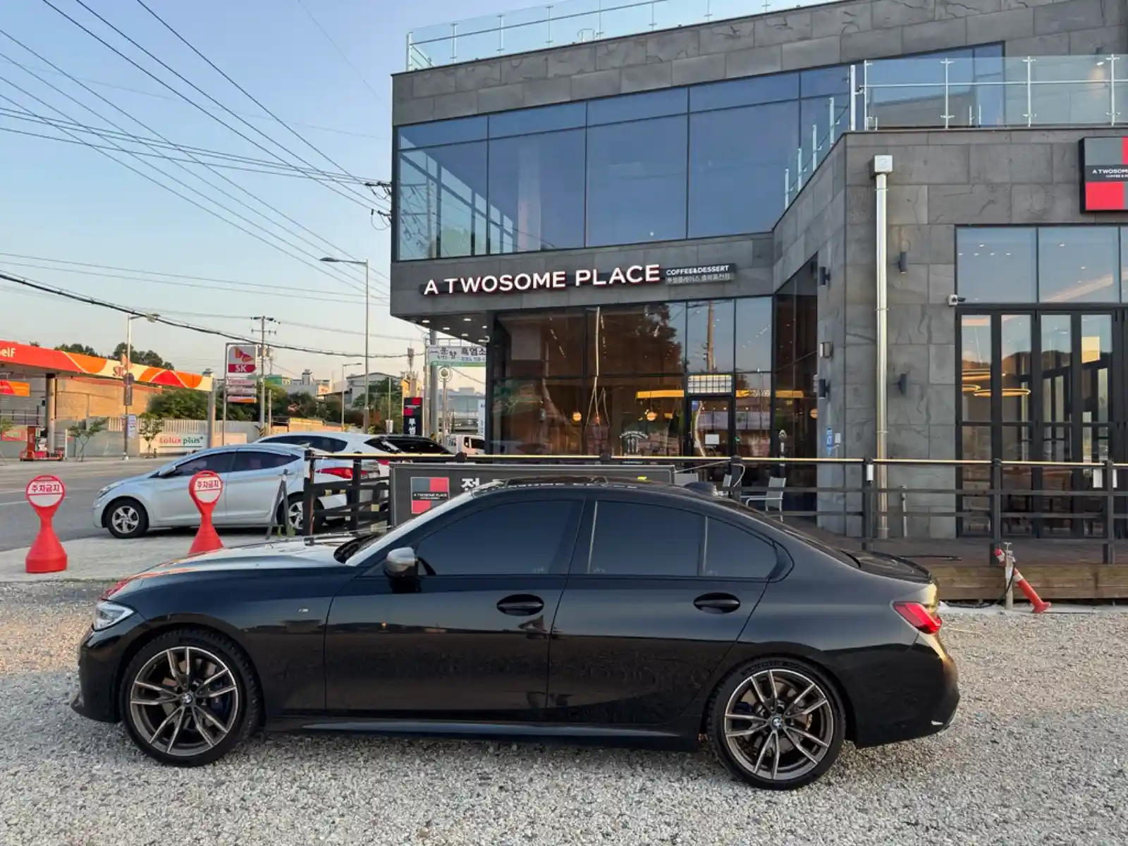BMW M340i Black Sapphire parked in front of a café — 3.5 years owner review and accessory recommendations by TACO