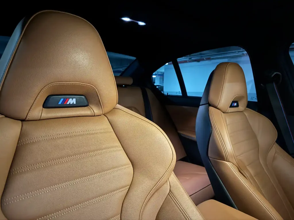 BMW M340i interior front seats with M logo — detail of BMW identity and owner customization by TACO
