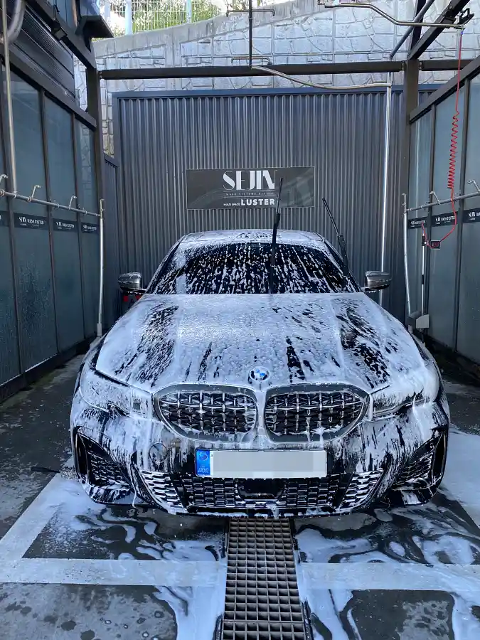 BMW M340i Black Sapphire covered in foam during self car wash — owner maintenance routine by TACO