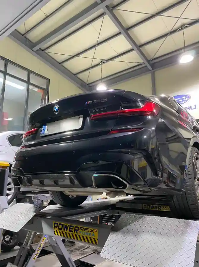 BMW M340i Black Sapphire on lift with M Performance exhaust and carbon diffuser — installed scene by TACO