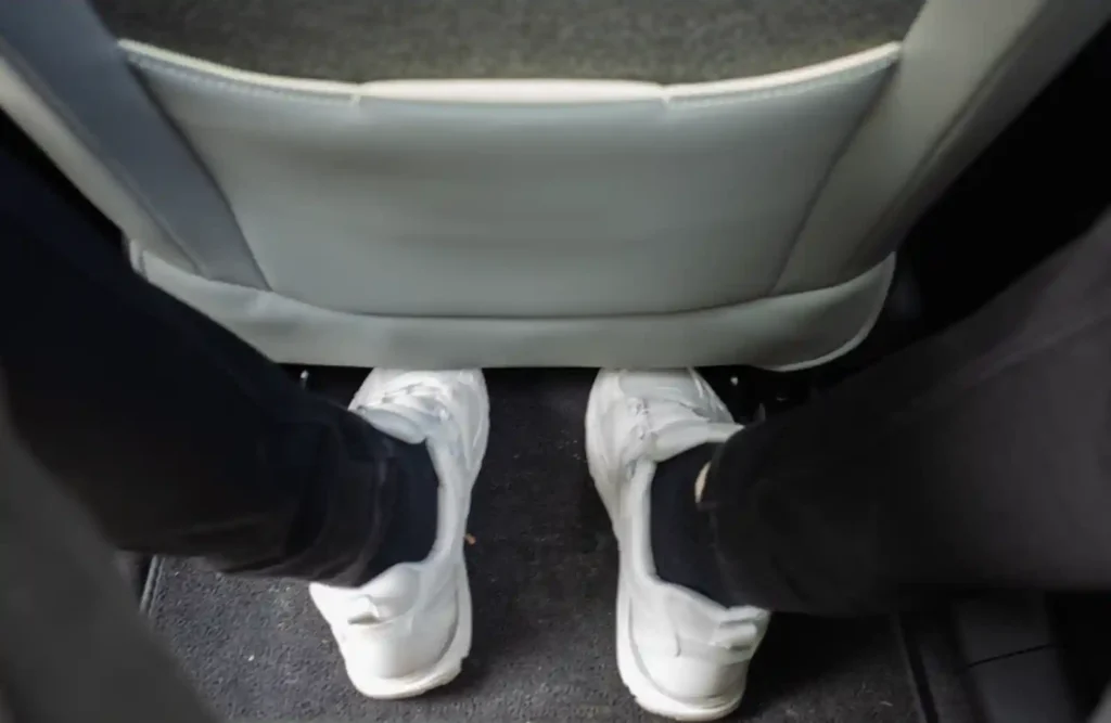 Rear legroom view of Volvo EX30 Cross Country showing limited foot space under front seat