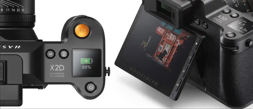 Hasselblad X2D 100C의 상단 조작부와 틸트 가능한 후면 디스플레이를 클로즈업한 이미지로, 황동 셔터 버튼, 디지털 정보창, 그리고 화면에 표시된 사진이 선명하게 보인다.