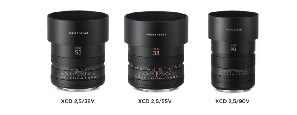 핫셀블라드 신형 XCD V 시리즈 렌즈 3종(38V, 55V, 90V)이 나란히 놓여 있는 제품 사진. 포커스 링의 거리계 눈금이 보인다.