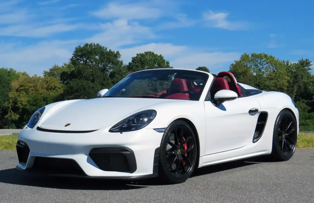 포르쉐 718 박스터 화이트 - 레드 인테리어를 갖춘 미드십 오픈탑 스포츠카