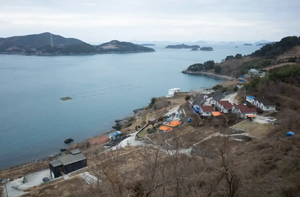 욕지도 해안 전망대에서 내려다본 어촌 마을과 한려수도 다도해, 겹겹이 펼쳐진 섬들과 양식장이 보이는 겨울 풍경